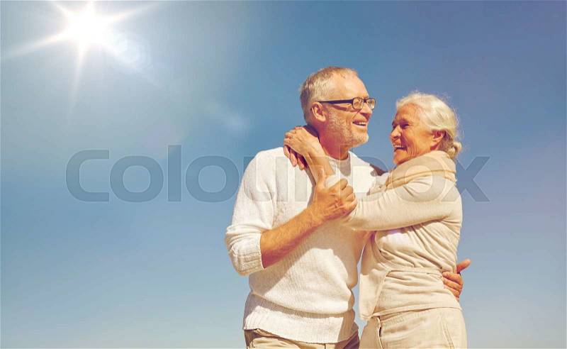 Family, love and people concept - happy senior couple hugging outdoors, stock photo