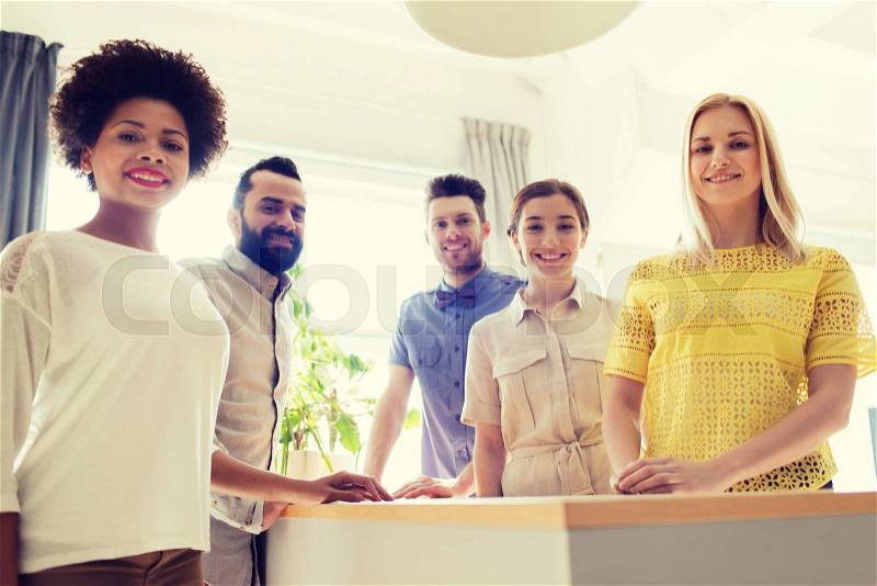 Business, startup and office concept - happy business team in office, stock photo