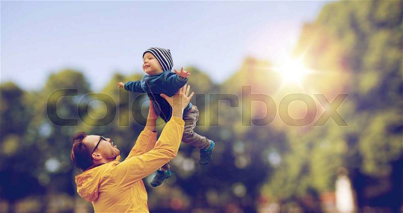 Family, childhood, fatherhood, leisure and people concept - happy father and little son playing and having fun outdoors over summer park background, stock photo