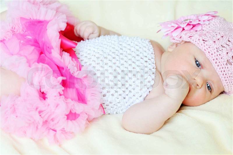Sweet newborn girl is wearing tutu skirt, stock photo