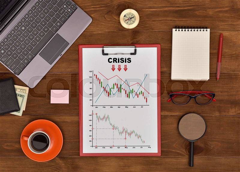Clipboard with Drawing crisis chart on Wooden Table, stock photo