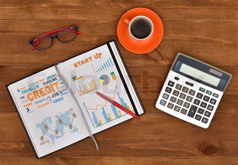 Start up concept drawing in diary and business elements on a table, stock photo