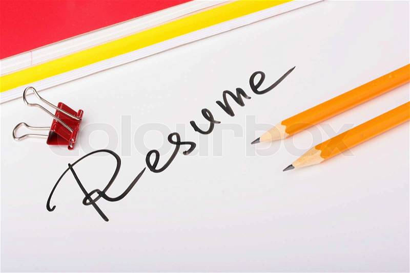 On a white background an inscription - Resume with two thick writing-books and pencils, stock photo