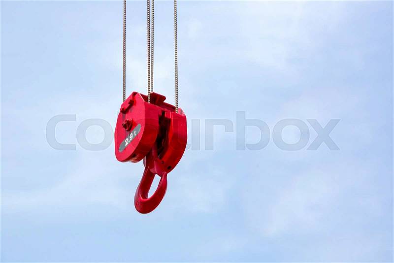 Metal hook of a crane against the sky, stock photo