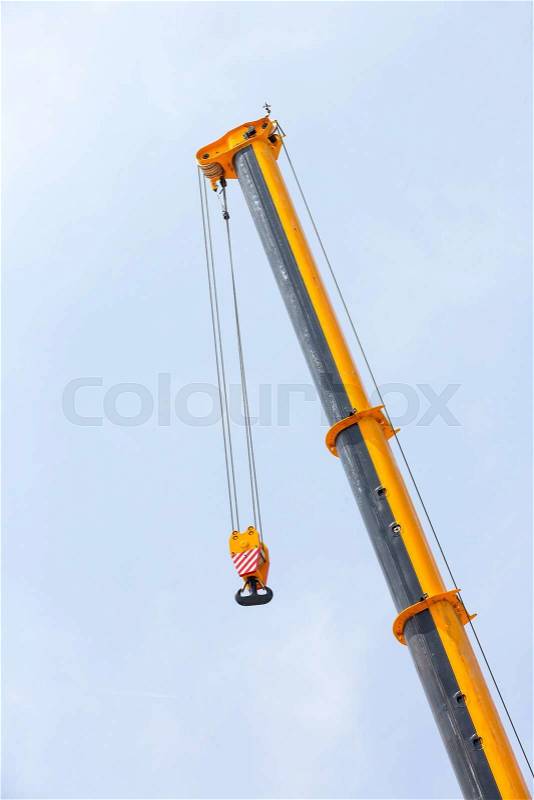 Metal hook of a crane against the sky, stock photo