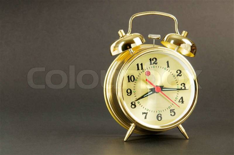 Time concept - alarm clock against colorful background, stock photo