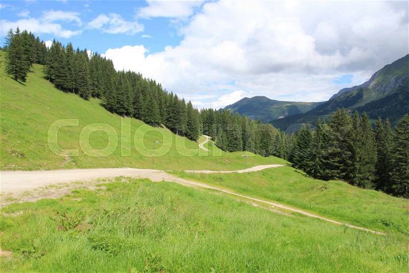 Blue sky with clouds and different hiking paths in the mountains in the village Brixen im Thale in Austria in the wonderful summer, stock photo