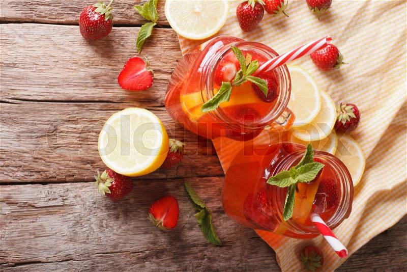 Summer strawberry lemonade with peppermint close-up in a glass jar on the table. horizontal view from above , stock photo
