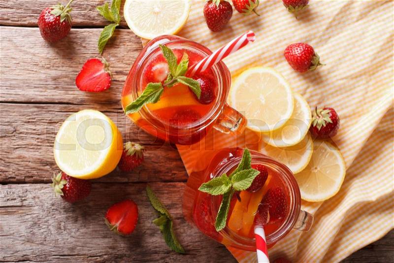 Cold strawberry lemonade with mint close up in a glass jar on the old table. horizontal view from above , stock photo