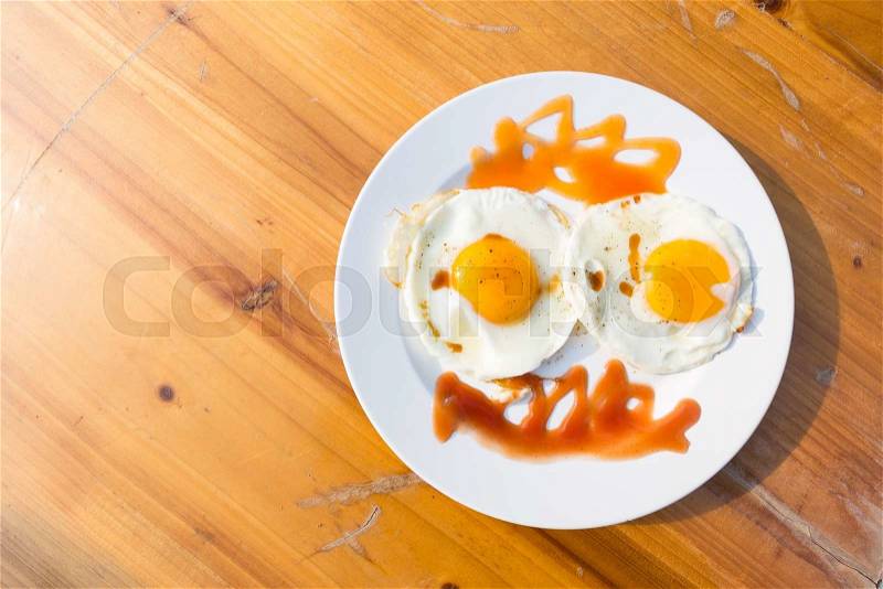 Egg breakfast dish. White dish with the sauce on the table, stock photo