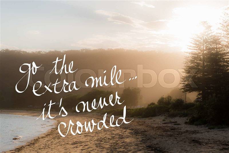 Go The Extra Mile Its Never Crowded message. Handwritten motivational text over sunset calm sunny beach background with vintage filter applied, stock photo