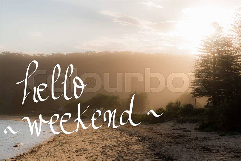Hello Weekend Greeting. Handwritten motivational text over sunset calm sunny beach background with vintage filter applied, stock photo