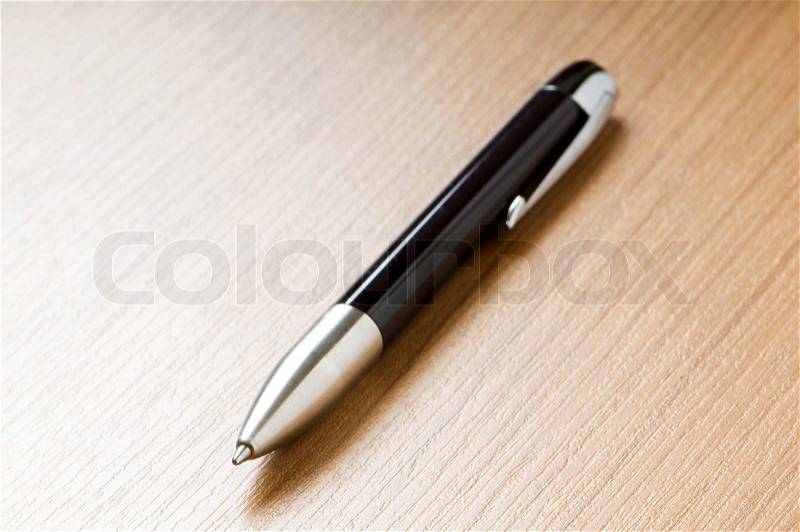 Writing silver pen on the wooden background, stock photo