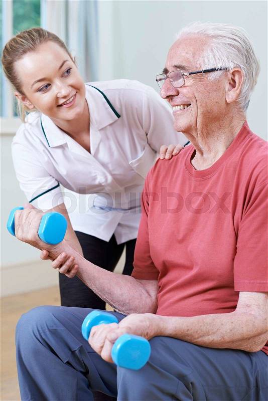 Senior Male Working With Physiotherapist Using Weights, stock photo