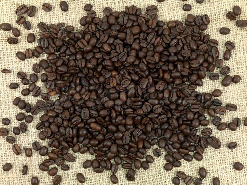 Coffee beans on a brown hessian bag, stock photo