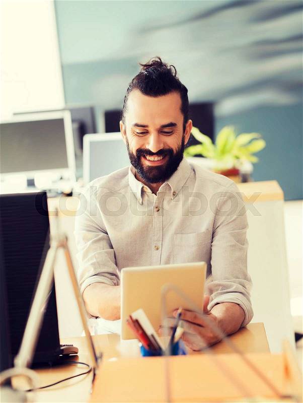 Business, startup and people concept - happy businessman or creative male office worker with tablet pc computer, stock photo