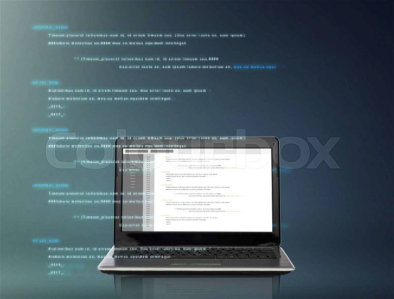 Technology and programming concept - laptop computer with coding on screen over gray background, stock photo