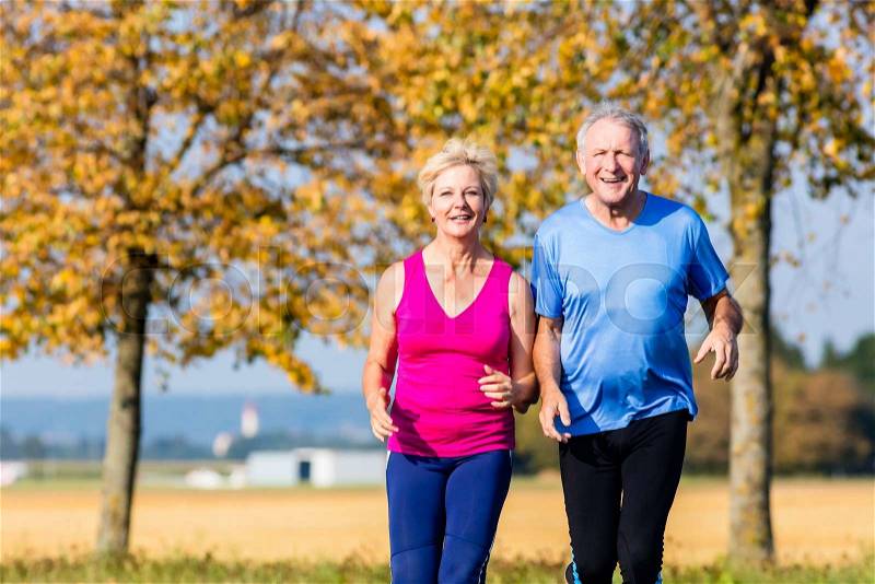 Senior woman and man running doing fitness exercises, stock photo