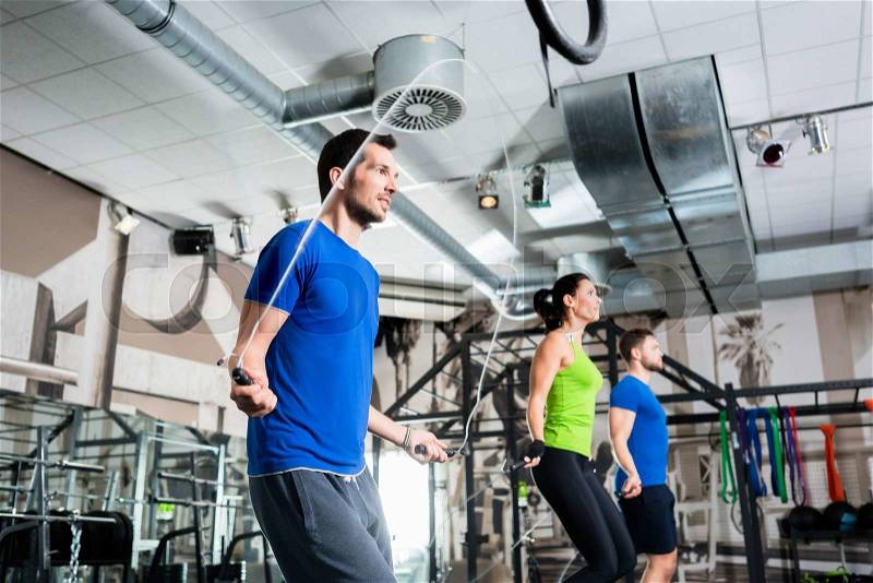 Group rope skipping in functional training gym as fitness exercise, stock photo