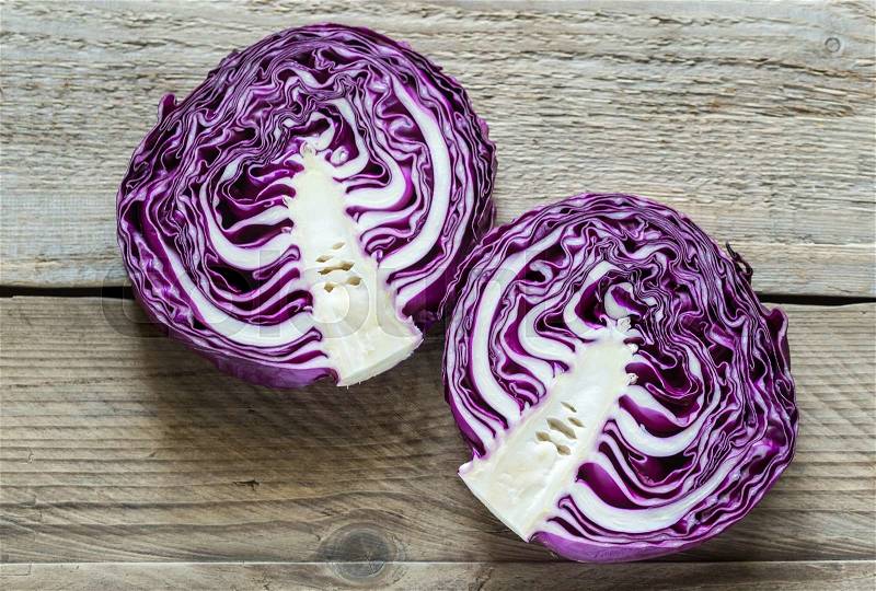 Two halves of red cabbage on the wooden background, stock photo
