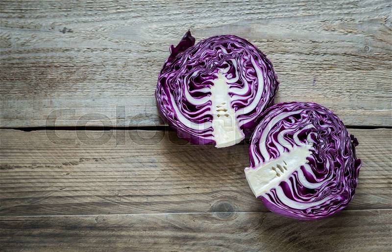 Two halves of red cabbage on the wooden background, stock photo