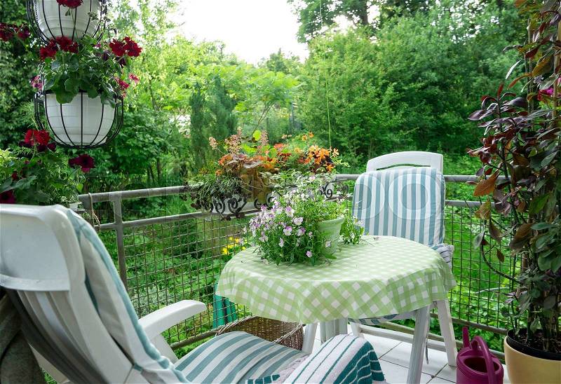 Summer Terrace or Balcony with small Table, Chair and Flowers, stock photo