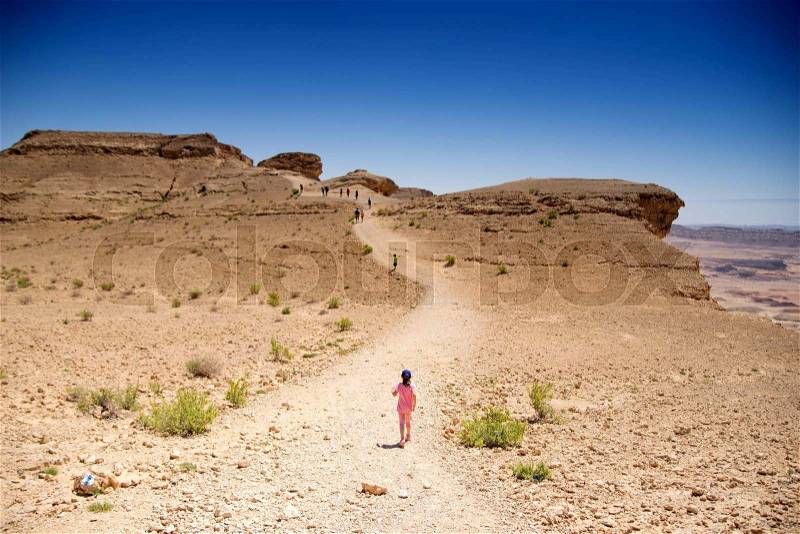 People hiking for health in israeli desert travel, stock photo