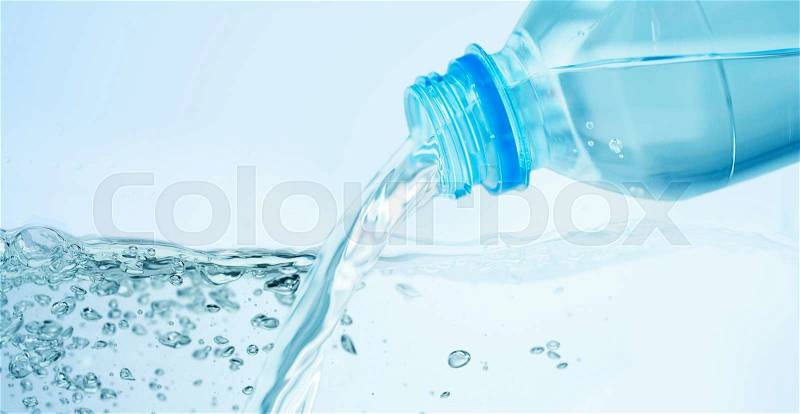 Drinking, healthy eating and food storage concept - close up of drinking water pouring from plastic bottle over blue background, stock photo