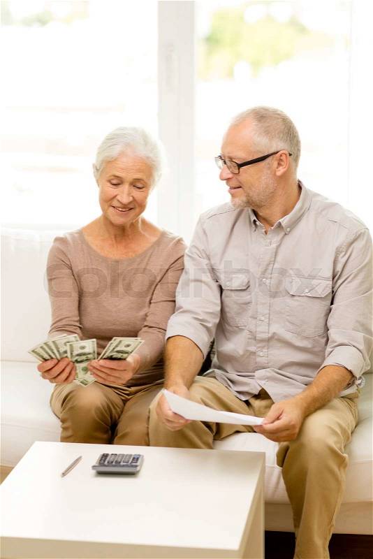 Family, business, savings, age and people concept - smiling senior couple with papers, money and calculator at home, stock photo