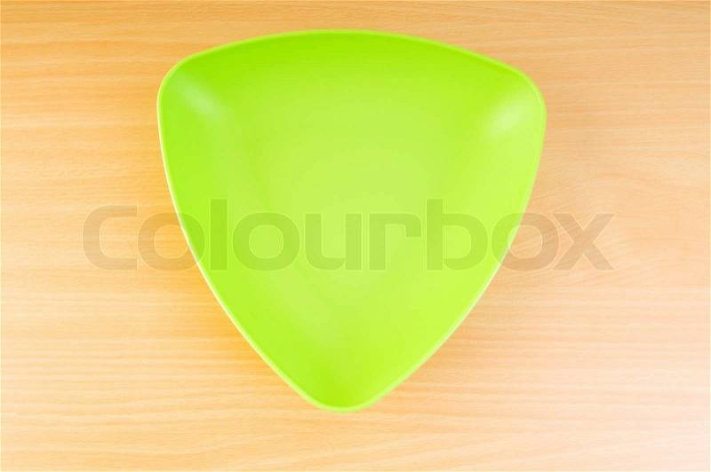 Empty plate on the wooden table, stock photo