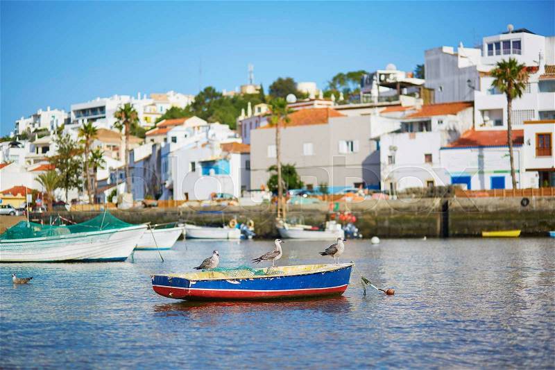Scenic view of fishing boats in Ferragudo, Algarve, Portugal, stock photo