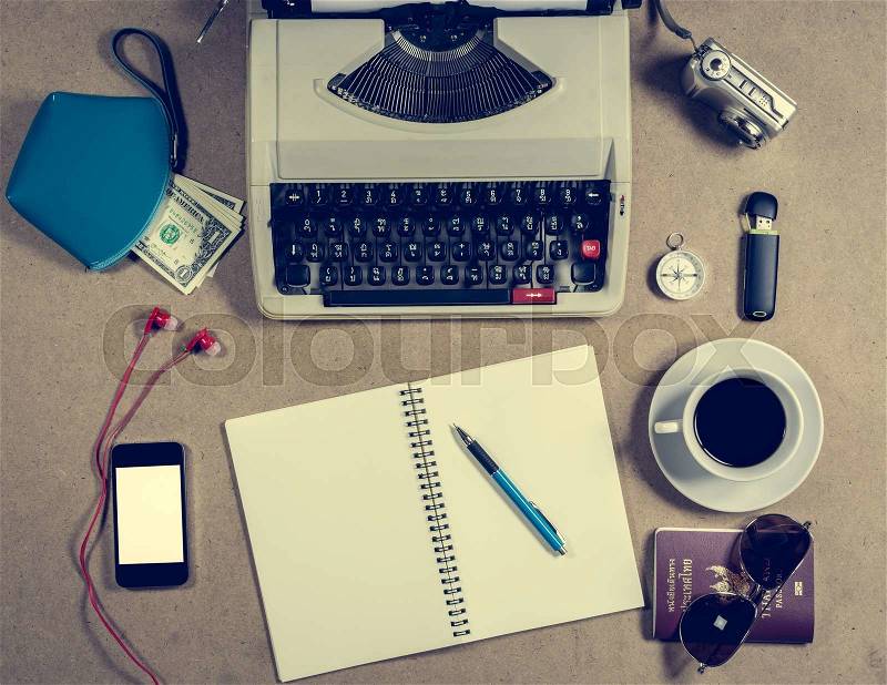 Typewriter and personal items on the vintage table, stock photo
