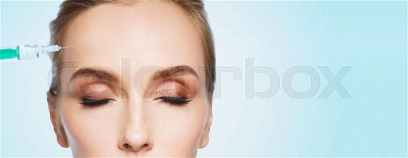 People, cosmetology, plastic surgery, anti-aging and beauty concept - beautiful young woman face and syringe making lifting injection to forehead over blue background, stock photo