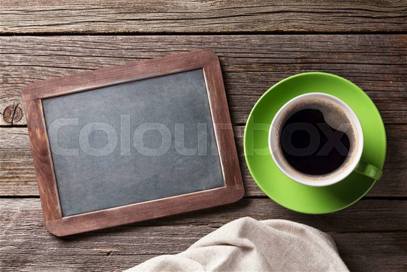 Blackboard for your text and coffee cup. Top view with copy space, stock photo