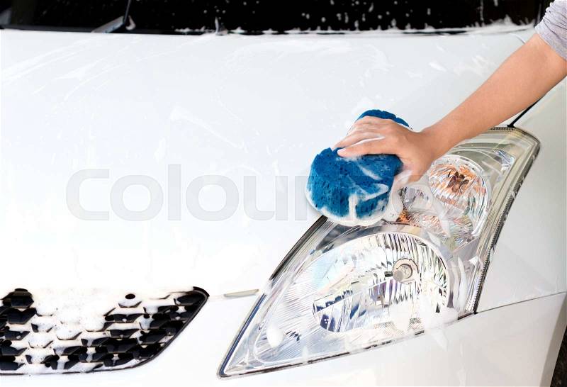 Hand using sponge washing car, stock photo