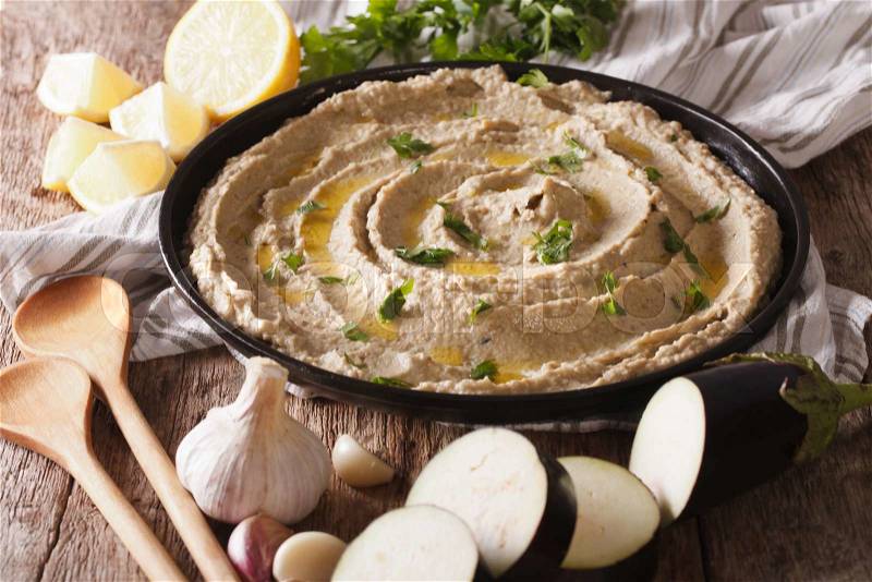 Arabic food baba ghanoush close-up on the plate and ingredients on the table. horizontal , stock photo
