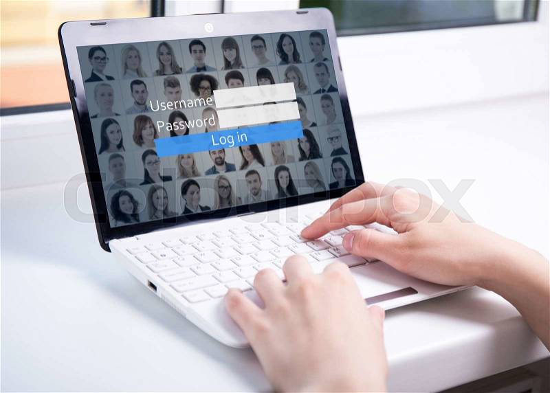 Close up of woman using laptop with login box on screen, stock photo