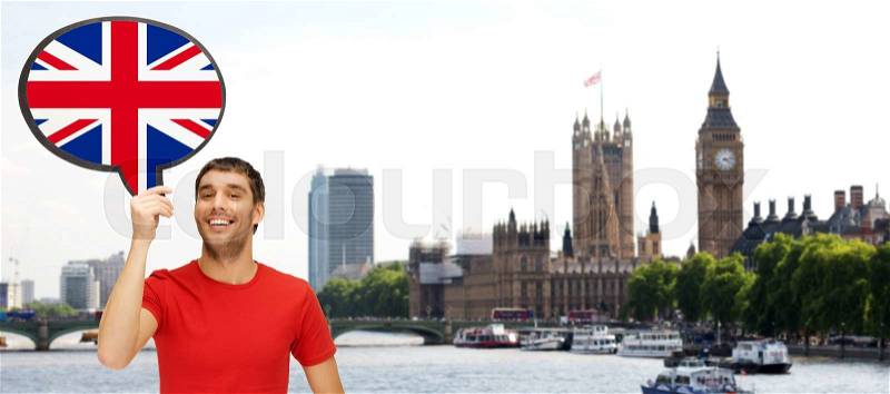 Foreign language, english, travel, people and communication concept - smiling young man holding text bubble of british flag over london city and big ben tower background, stock photo