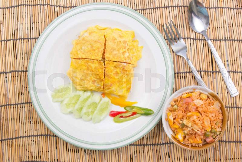 Fired rice with bacon Wrap eggs on white plate / cooking fried rice concept, stock photo