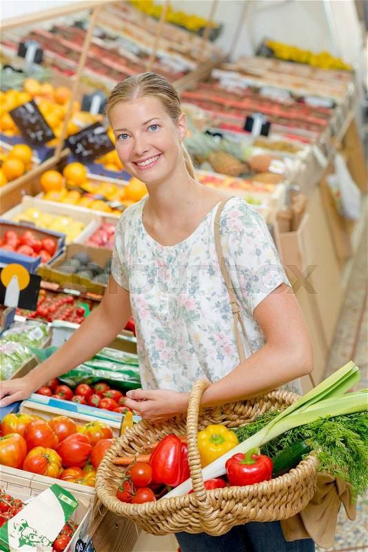 Lady buying vegetables, stock photo