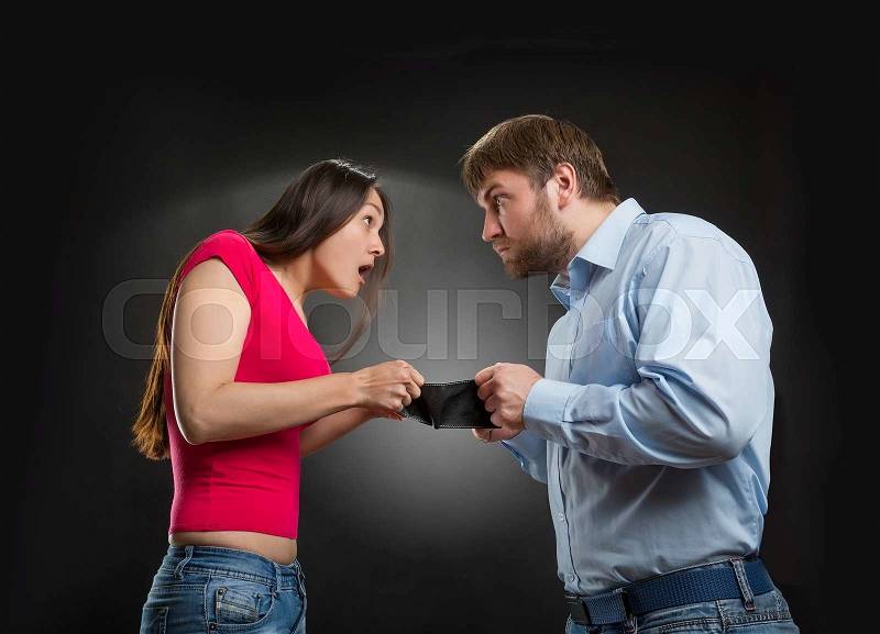 Woman and man looking for money in an empty wallet, stock photo