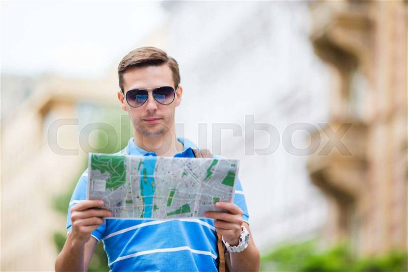 Caucasian tourist walking along the deserted streets of Europe. Young urban boy on vacation exploring european city cobblestone street, stock photo