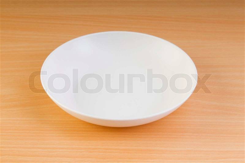 Empty plate on the wooden table, stock photo