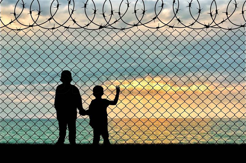 Refugee children concept. Silhouette of two children of refugees near the border on the background seascape, stock photo