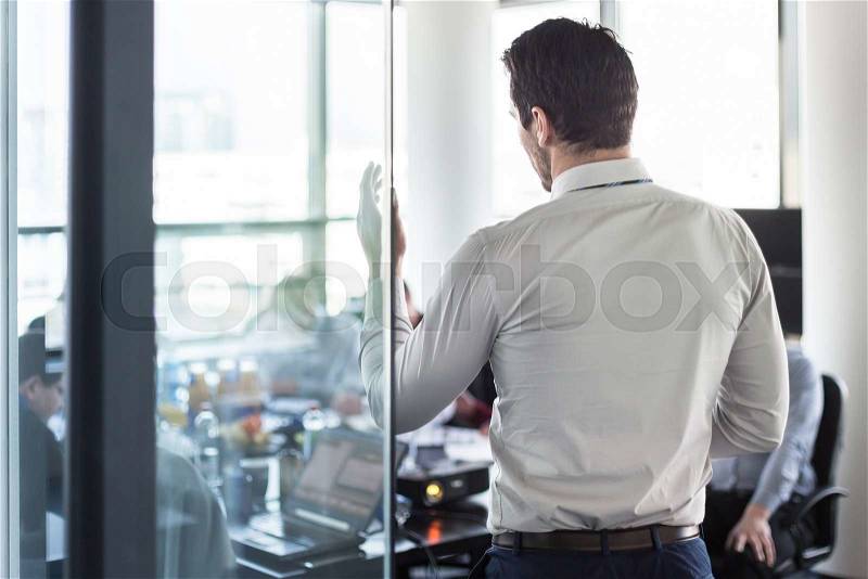 Business man making a presentation at office. Business executive delivering a presentation to his colleagues during meeting or in-house business training, explaining business plans to his employees. , stock photo