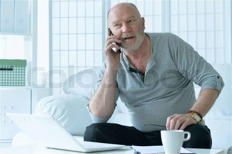 Portrait of a senior man with phone, stock photo
