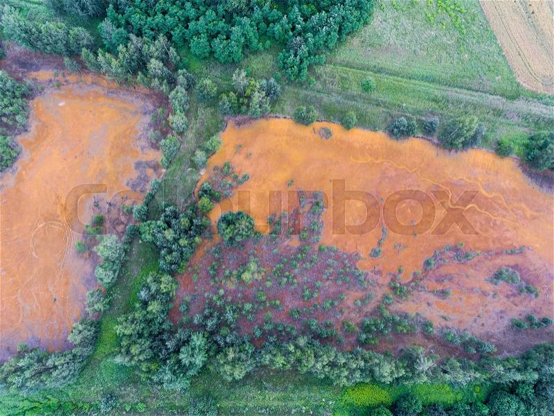 Old sulfuric acid natural tank orange color in south of Poland. , stock photo