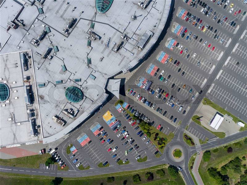 Supermarket roof and many cars in parking, viewed from above, stock photo