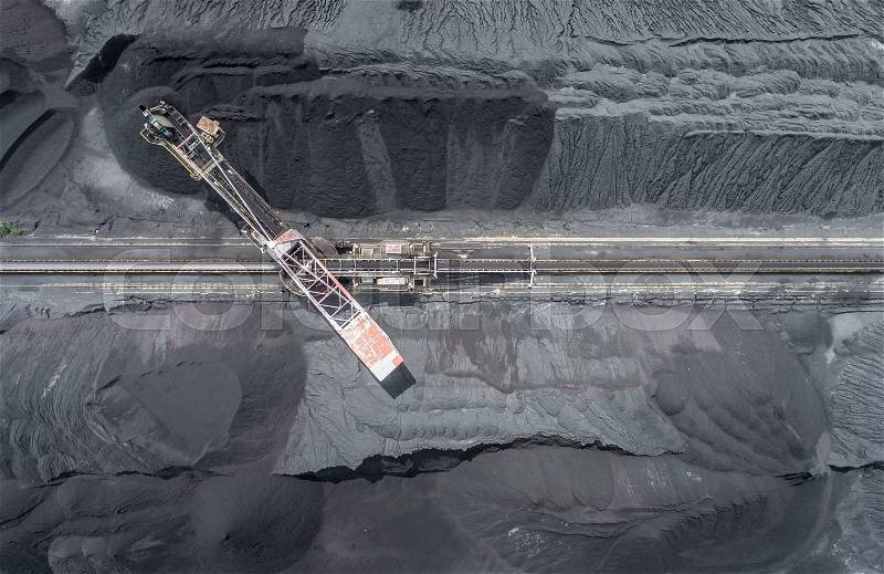 Mining excavator on the bottom surface mine. Brown coal deposits. View from above, stock photo