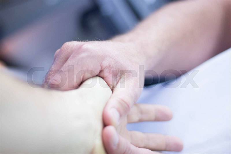 Myofascial osteopathy physiotherapy treatment by physiotherapist and osteopath in physical therapy rehabilitation treatment on patient on hand and wrist, stock photo